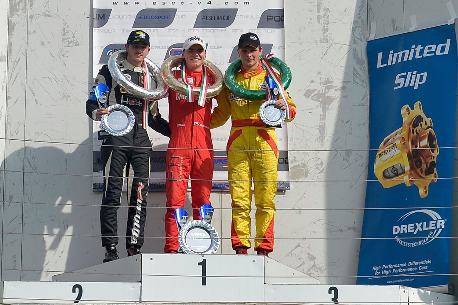 Tom Beckhäuser on the top step of the podium with the ESET V4 Cup winner's plate